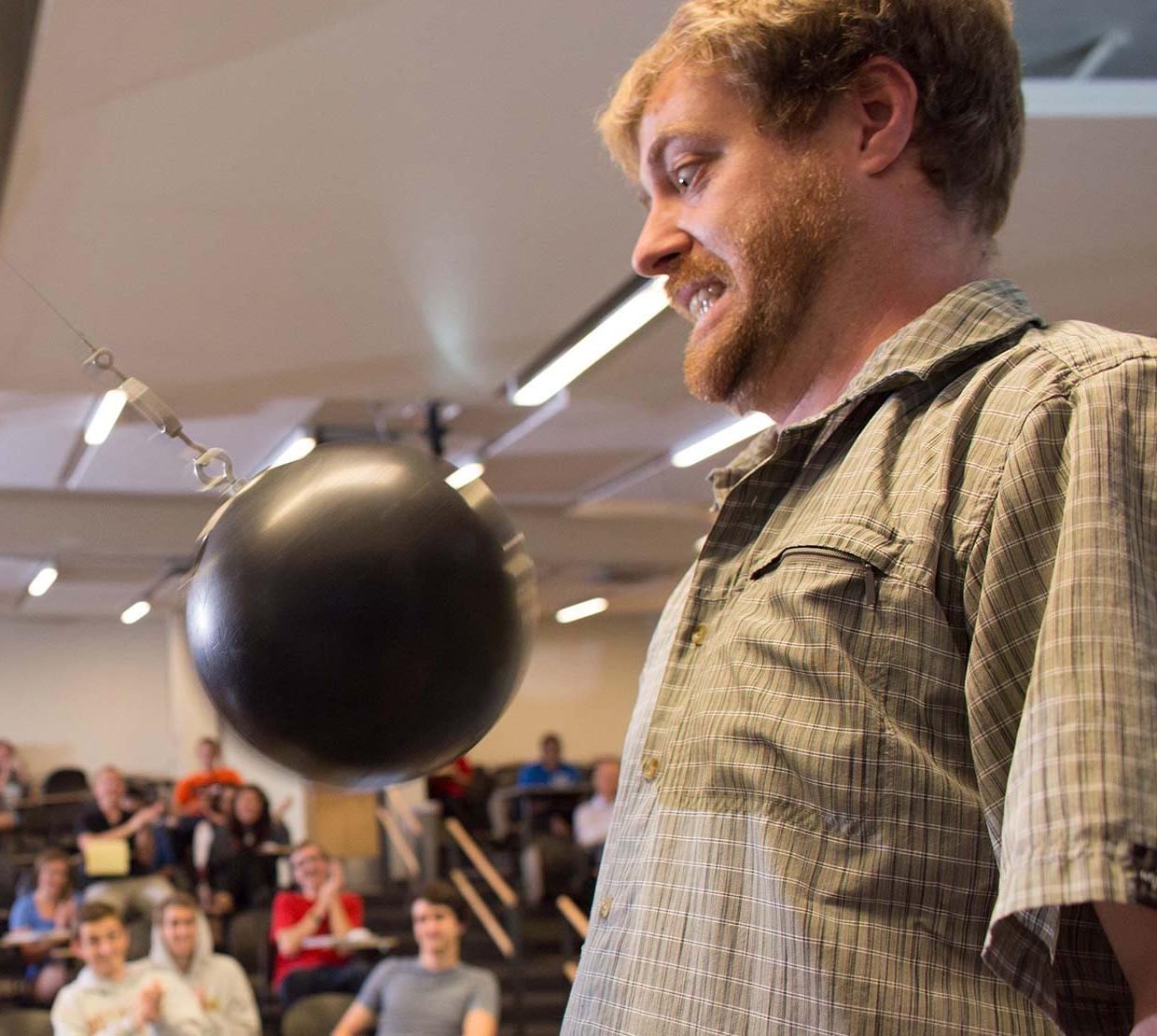 KC Walsh giving using bowling ball in lecture demo