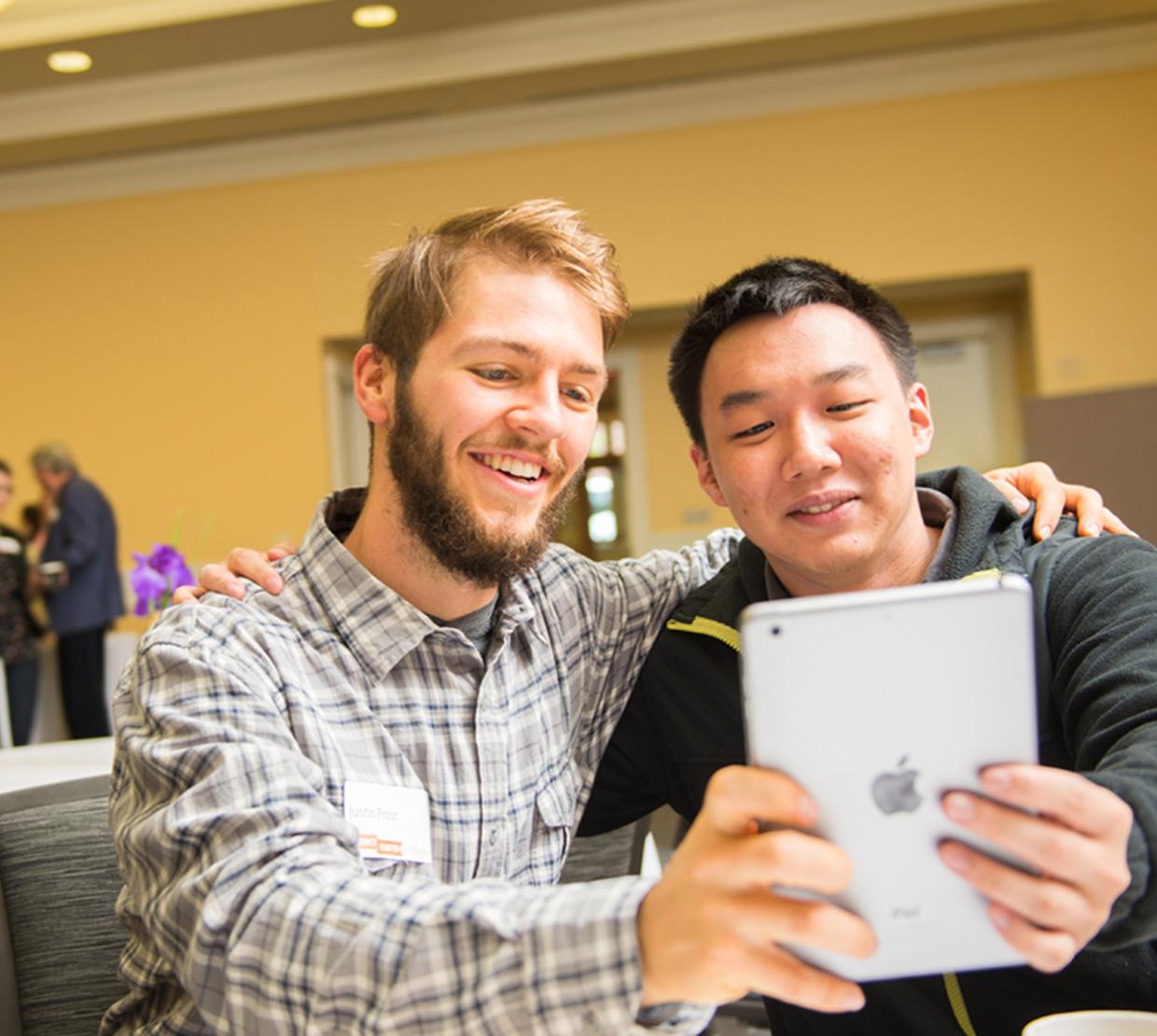 Justin Frost and colleague taking selfie on iPad