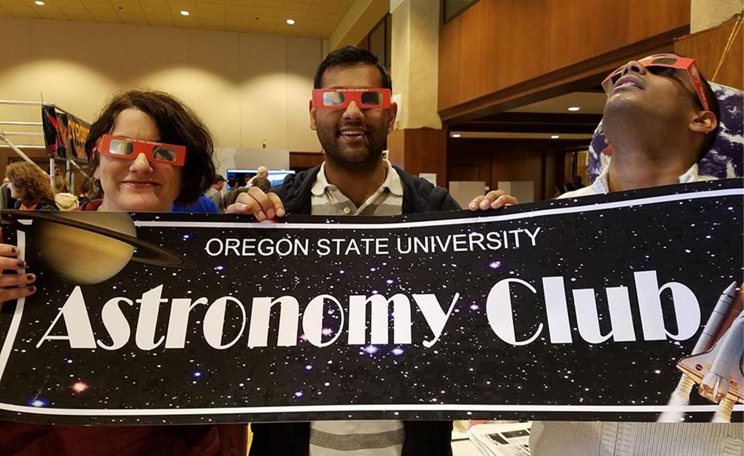 Astronomy Club members holding banner