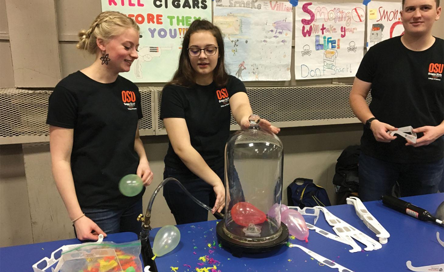 Physics students running a booth at Family Science Night