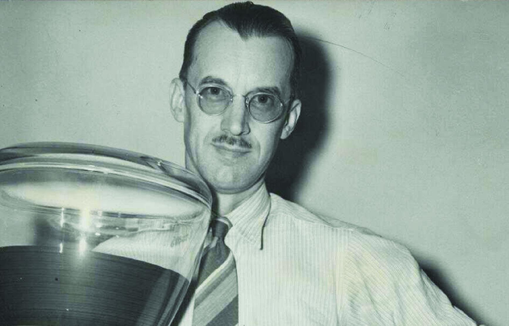 Edwin Yunker holding cathode tubes used in radar.