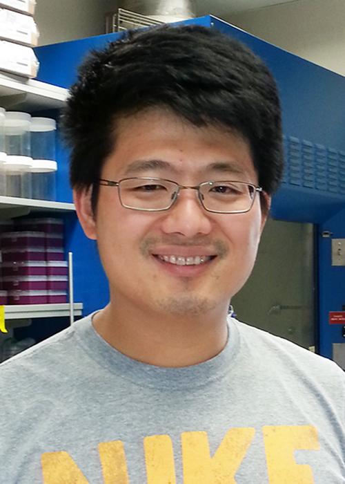 Kuo-Fu Tseng standing in lab space