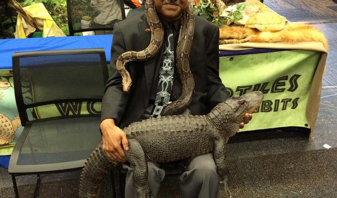 Sastry Pantula sitting with snake and crocodile