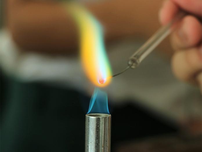 Flame test of element over burner.