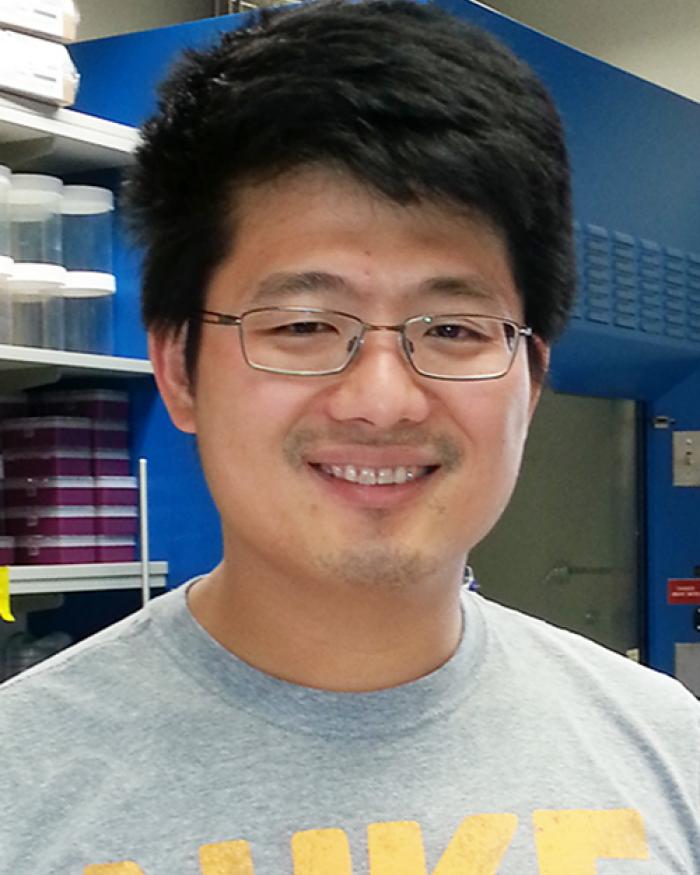 Kuo-Fu Tseng standing in lab space