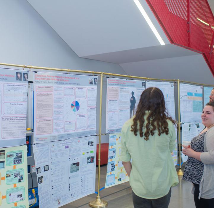 students looking through research posters