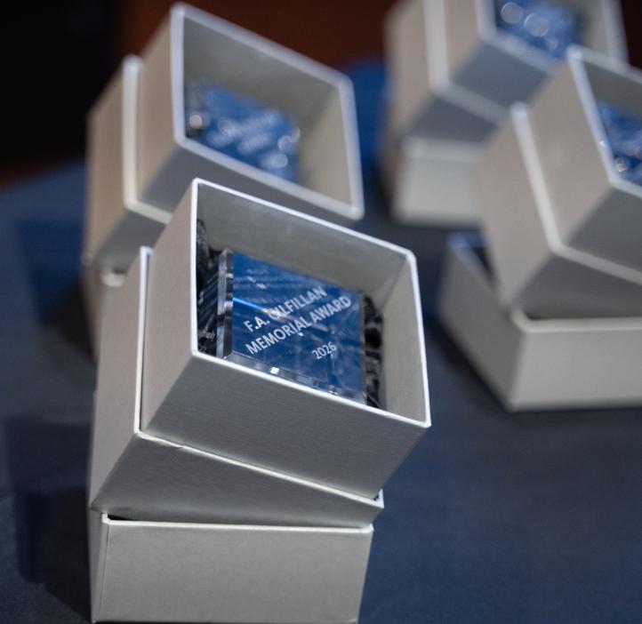 Glass cube awards sit on a table.