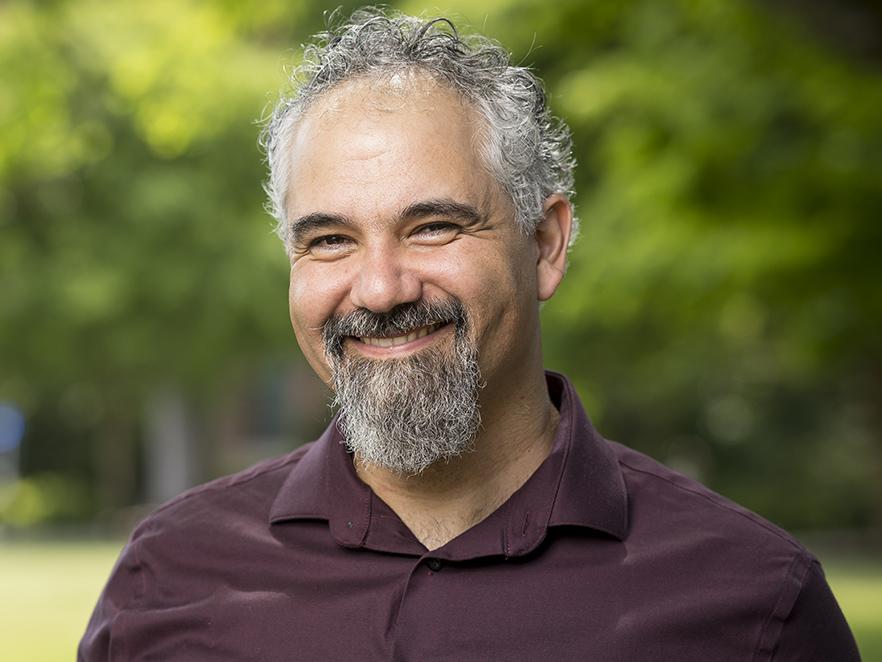 Headshot of Jeff Hazboun smiling on campus during summer